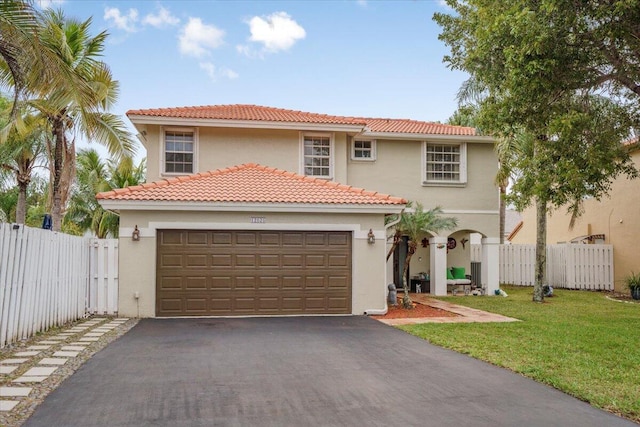 mediterranean / spanish house featuring a garage and a front lawn