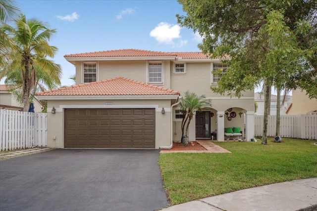 mediterranean / spanish-style house with a garage and a front lawn