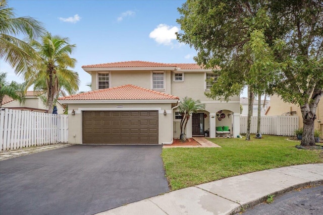 mediterranean / spanish-style home with a front lawn and a garage