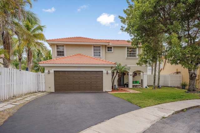 mediterranean / spanish-style house with a front yard and a garage