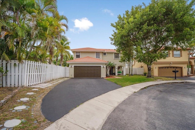 mediterranean / spanish-style house with a garage