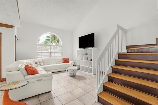 tiled living room with a textured ceiling and vaulted ceiling