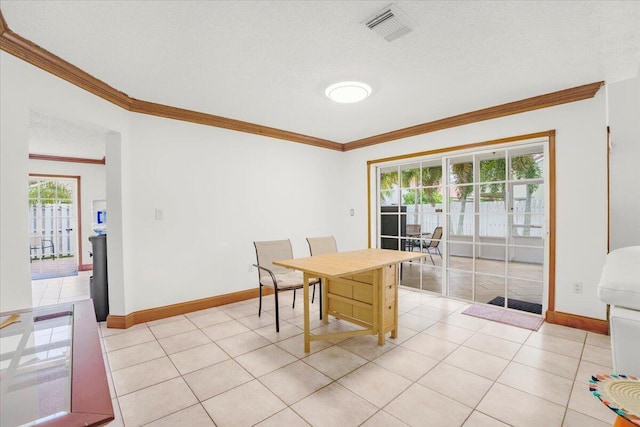 dining room featuring a textured ceiling, light tile patterned floors, and ornamental molding