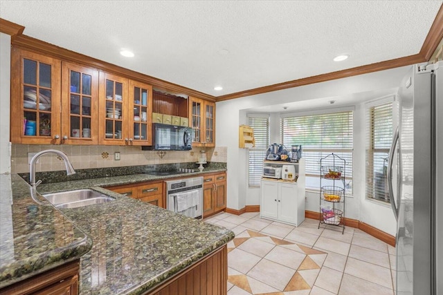 kitchen with decorative backsplash, stainless steel appliances, crown molding, sink, and light tile patterned floors