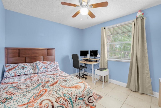 tiled bedroom with ceiling fan and a textured ceiling