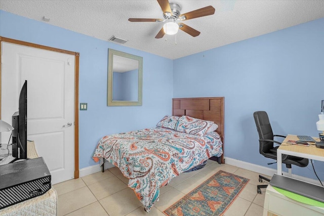 tiled bedroom featuring a textured ceiling and ceiling fan