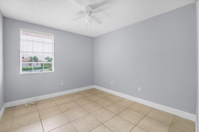 unfurnished room with light tile patterned floors, a textured ceiling, and ceiling fan