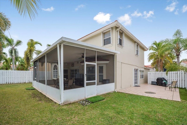 back of property featuring a patio area, a sunroom, and a yard