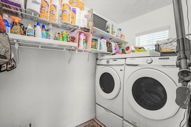 laundry room with independent washer and dryer and a textured ceiling