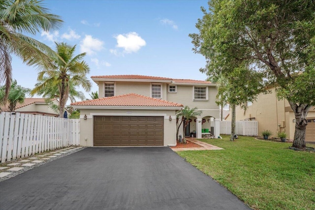 mediterranean / spanish house with a garage and a front lawn