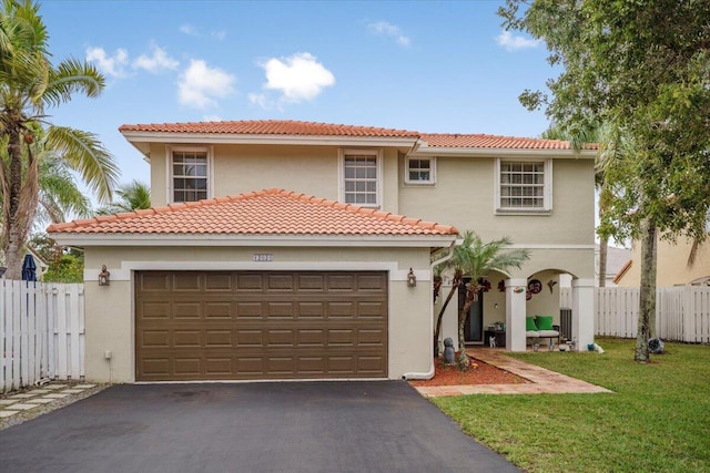 mediterranean / spanish home featuring a garage and a front lawn