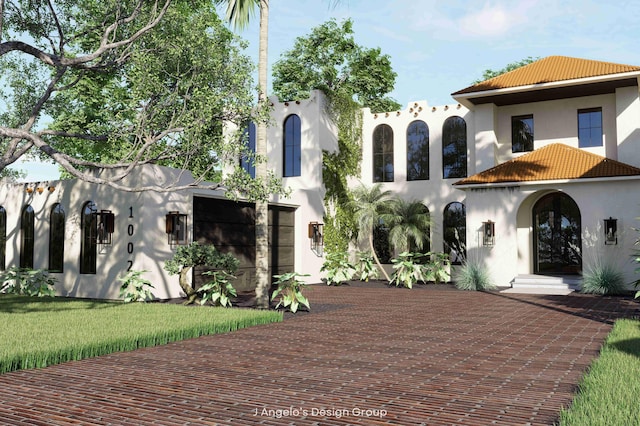 mediterranean / spanish house with a front yard