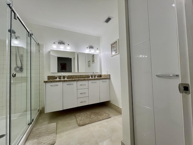 bathroom featuring vanity, tile patterned floors, and walk in shower