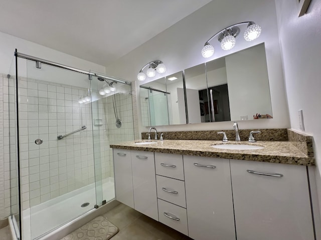 bathroom with tile patterned flooring, vanity, and an enclosed shower