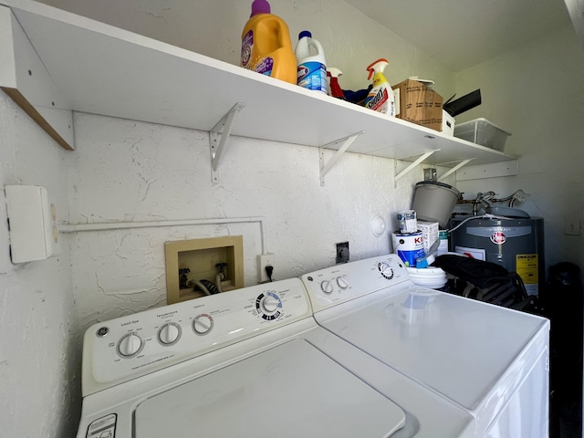 clothes washing area featuring washing machine and dryer and electric water heater