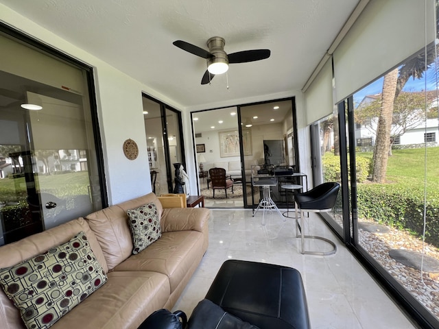 sunroom with ceiling fan