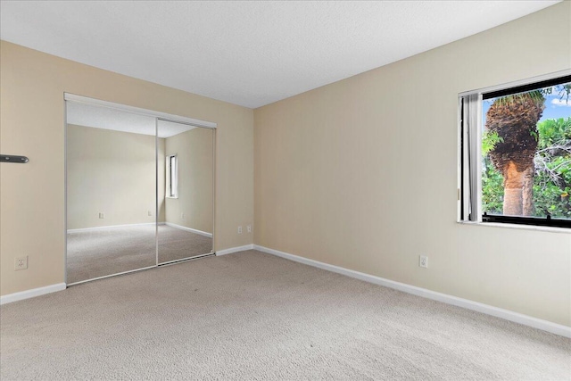 unfurnished bedroom with carpet and a closet