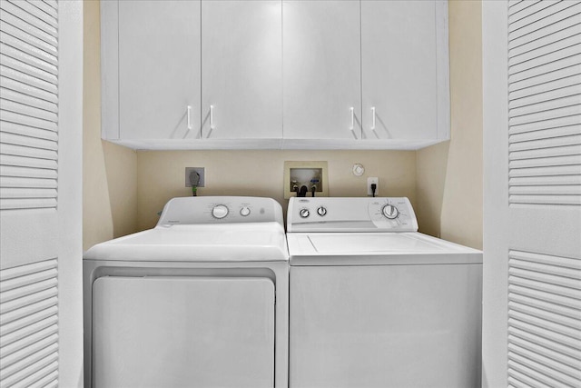 washroom with cabinets and separate washer and dryer