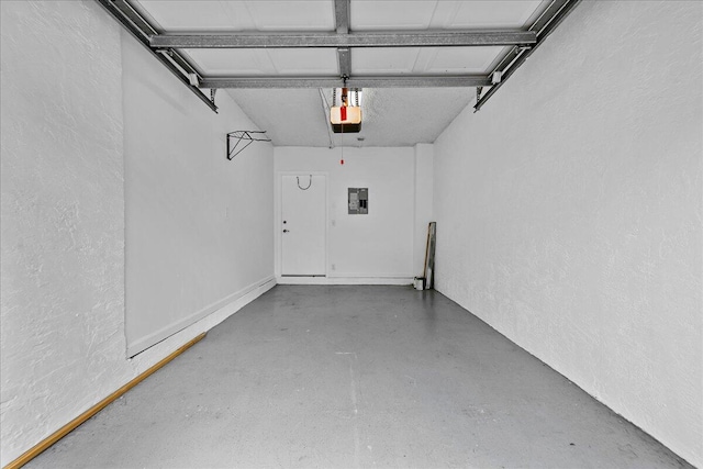 41 Uno Lago Dr, Juno Beach, FL 33408 - garage featuring a garage door opener, electric panel, and a textured wall