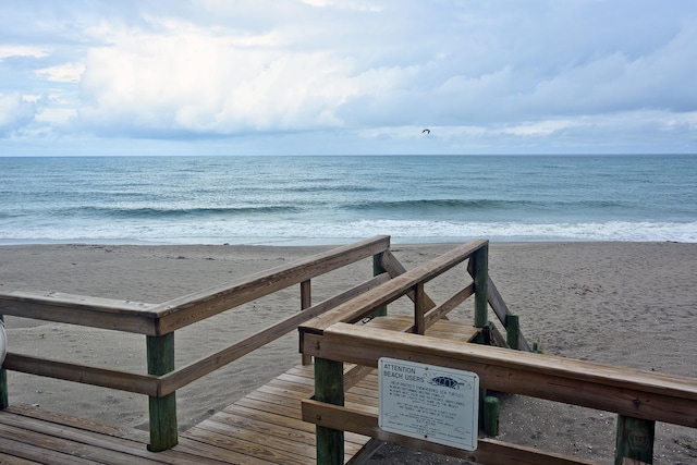 view of property's community featuring a water view and a view of the beach