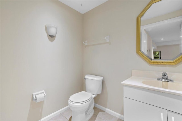 bathroom with tile patterned floors, vanity, and toilet