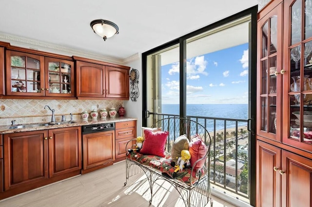 bar with light stone countertops, dishwasher, sink, decorative backsplash, and a water view