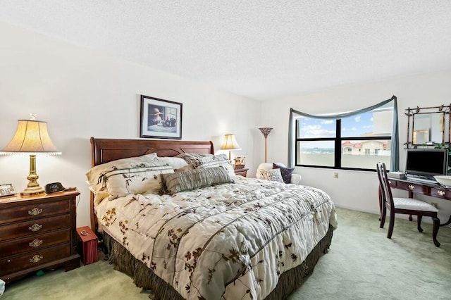 bedroom featuring a textured ceiling and light carpet