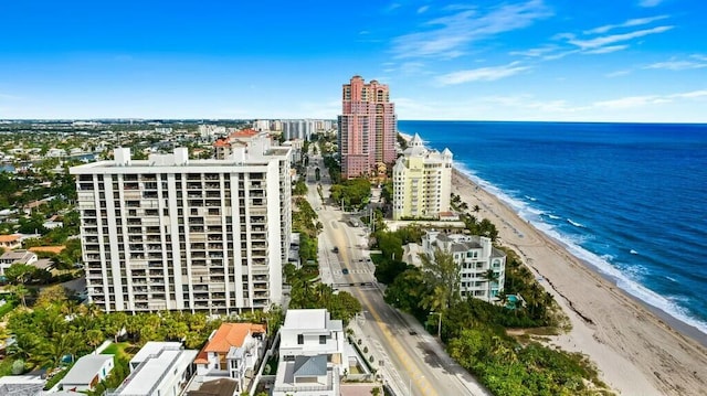 bird's eye view featuring a water view and a beach view