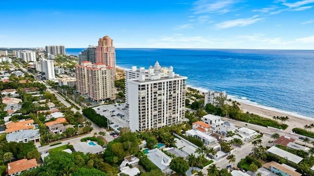 drone / aerial view with a water view and a beach view