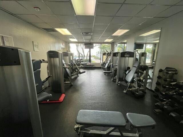 gym featuring a paneled ceiling