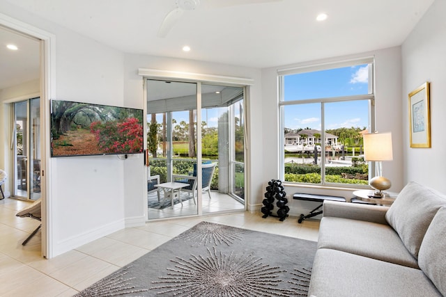 living room featuring ceiling fan and light tile patterned floors