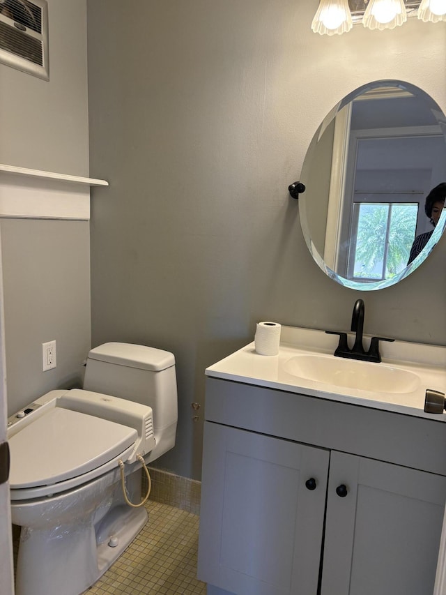 bathroom featuring tile patterned floors, vanity, and toilet