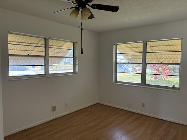 empty room with ceiling fan and hardwood / wood-style flooring