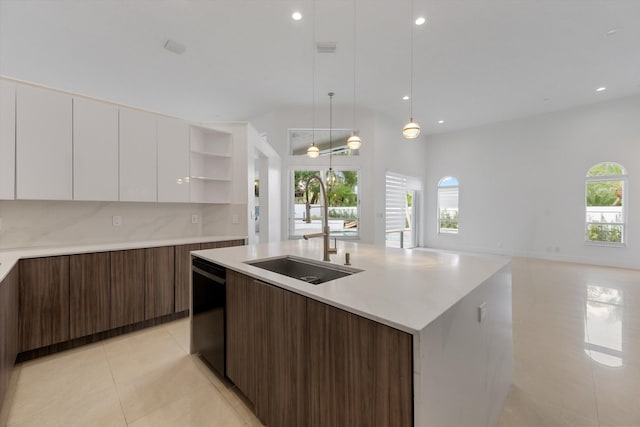 kitchen with dishwasher, sink, an island with sink, decorative light fixtures, and white cabinetry