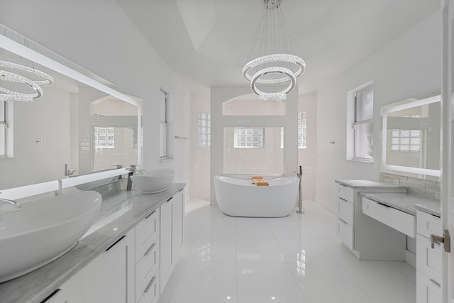 bathroom with a tub, tile patterned flooring, a chandelier, vanity, and tile walls