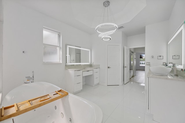 bathroom featuring a bathtub, vanity, tile patterned floors, a tray ceiling, and a chandelier