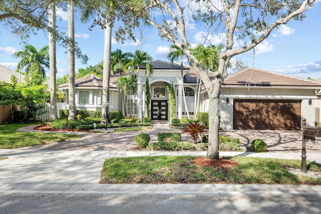 view of front of property with a garage and french doors