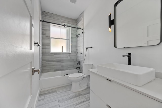 full bathroom with vanity, toilet, and bath / shower combo with glass door