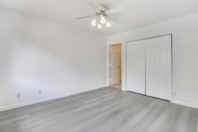 unfurnished bedroom with ceiling fan, light hardwood / wood-style floors, and a closet