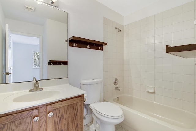 full bathroom with toilet, vanity, and tiled shower / bath