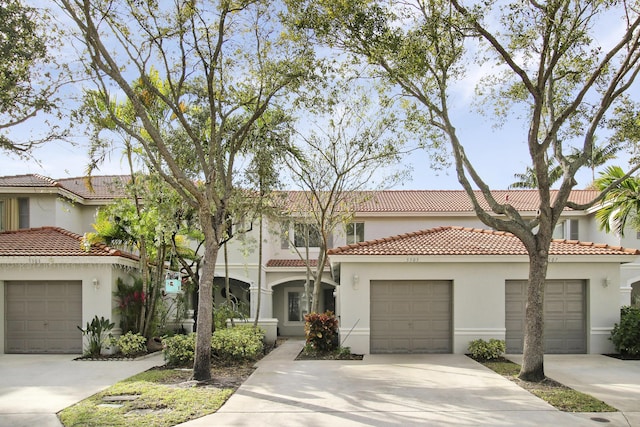 mediterranean / spanish-style home with a garage