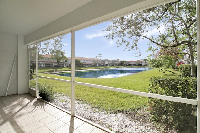 unfurnished sunroom featuring a water view