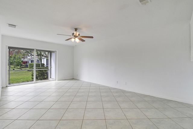 tiled empty room featuring ceiling fan