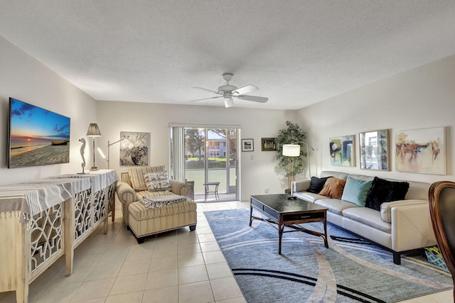 tiled living room featuring ceiling fan and a textured ceiling