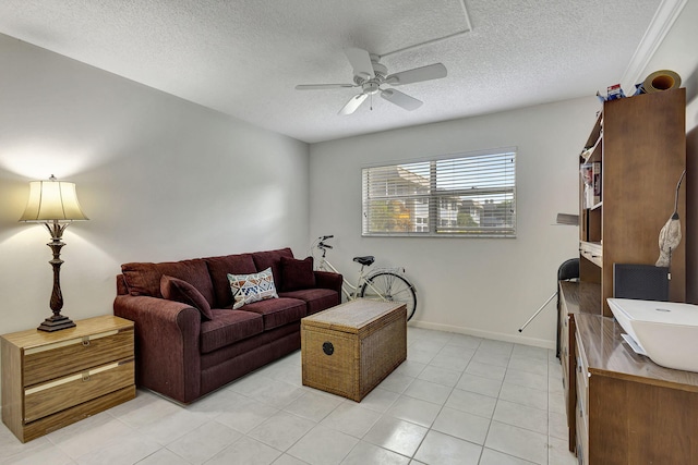 tiled living room featuring ceiling fan and a textured ceiling