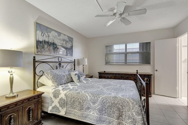 tiled bedroom featuring a textured ceiling and ceiling fan