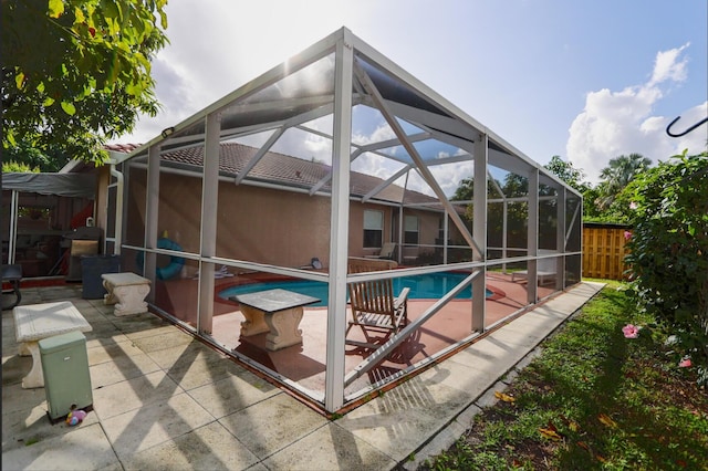 view of swimming pool with a lanai and a patio