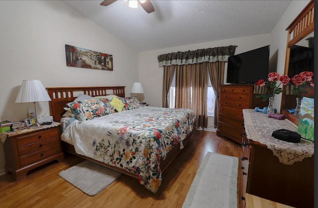 bedroom featuring hardwood / wood-style flooring, ceiling fan, and lofted ceiling