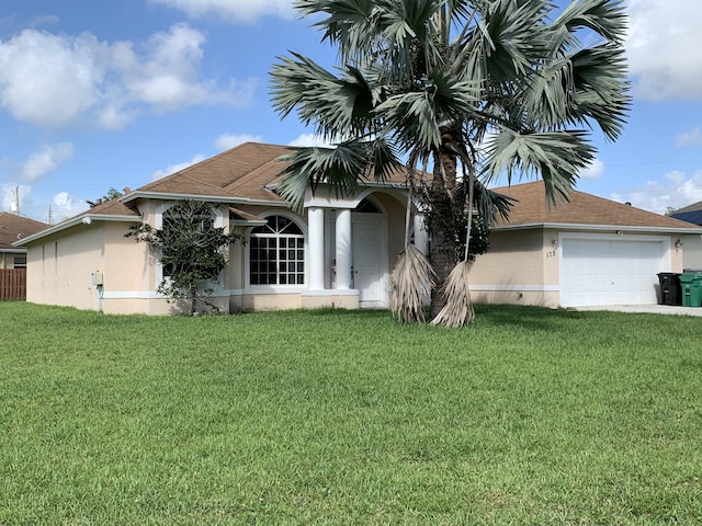 view of front of home with a garage and a front yard