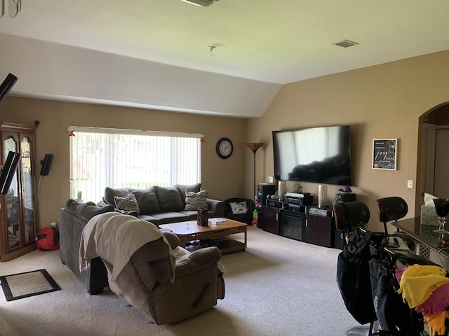 living room featuring light carpet and vaulted ceiling